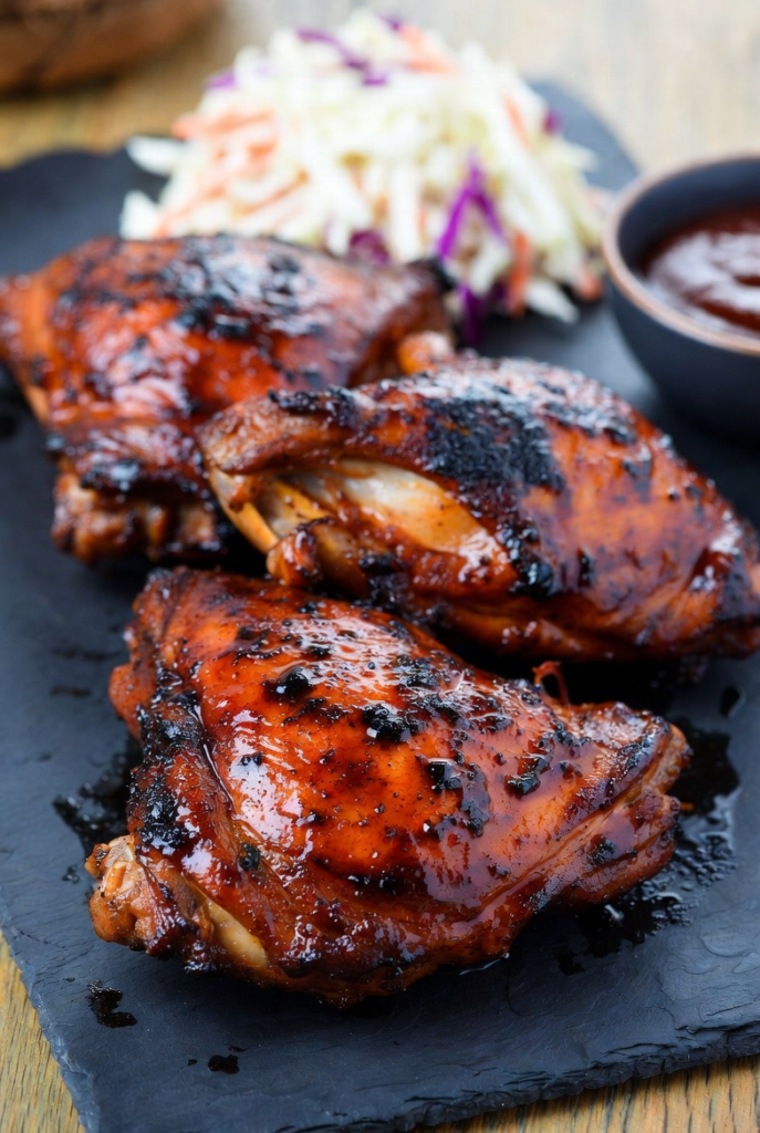 Grilled BBQ chicken thighs with caramelized glaze and grill marks